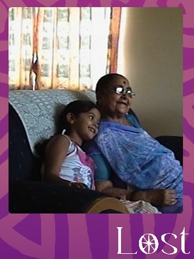 Gallery Image: Text reads: LOST; on a purple border around an image of a granddaughter and grandmother sitting next to each other on a couch, leaning into one another and smiling. 