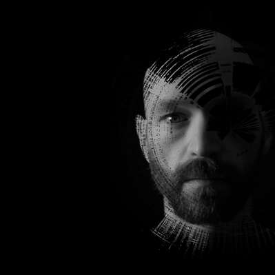 A black background with Aaron Collier's face, overlayed with circular waveform patterns. He is bald with a beard and is looking directly at the camera with a serious expression.