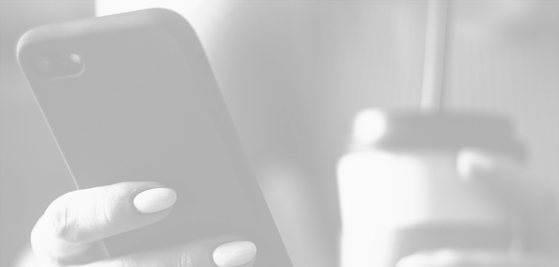Detailed photo of phone and coffee close up