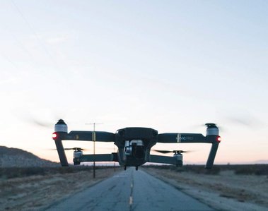 drone hovering over center of highway