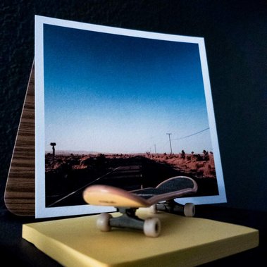 highway postcard standing with skateboard figurine in front