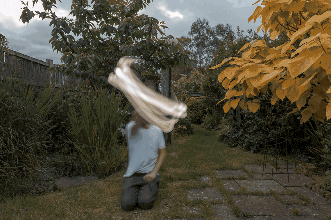 animated gif showing the artists swinging a light around his head to create a ring of light.