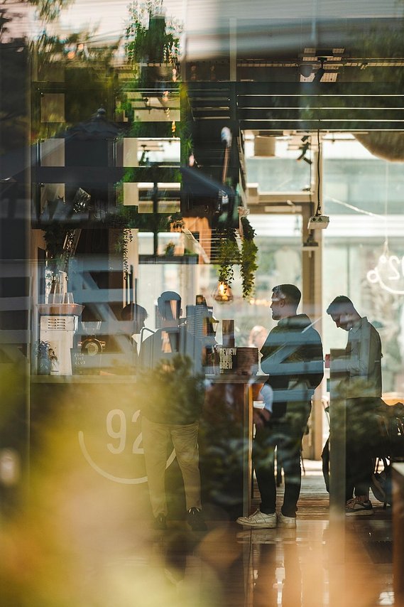 URBAN LIFESTYLE AND LOCAL AREA PHOTOGRAPHY OF SPINNINGFIELDS, MANCHESTER, lifestyle photography showing people inside a coffee shop queueing at counter