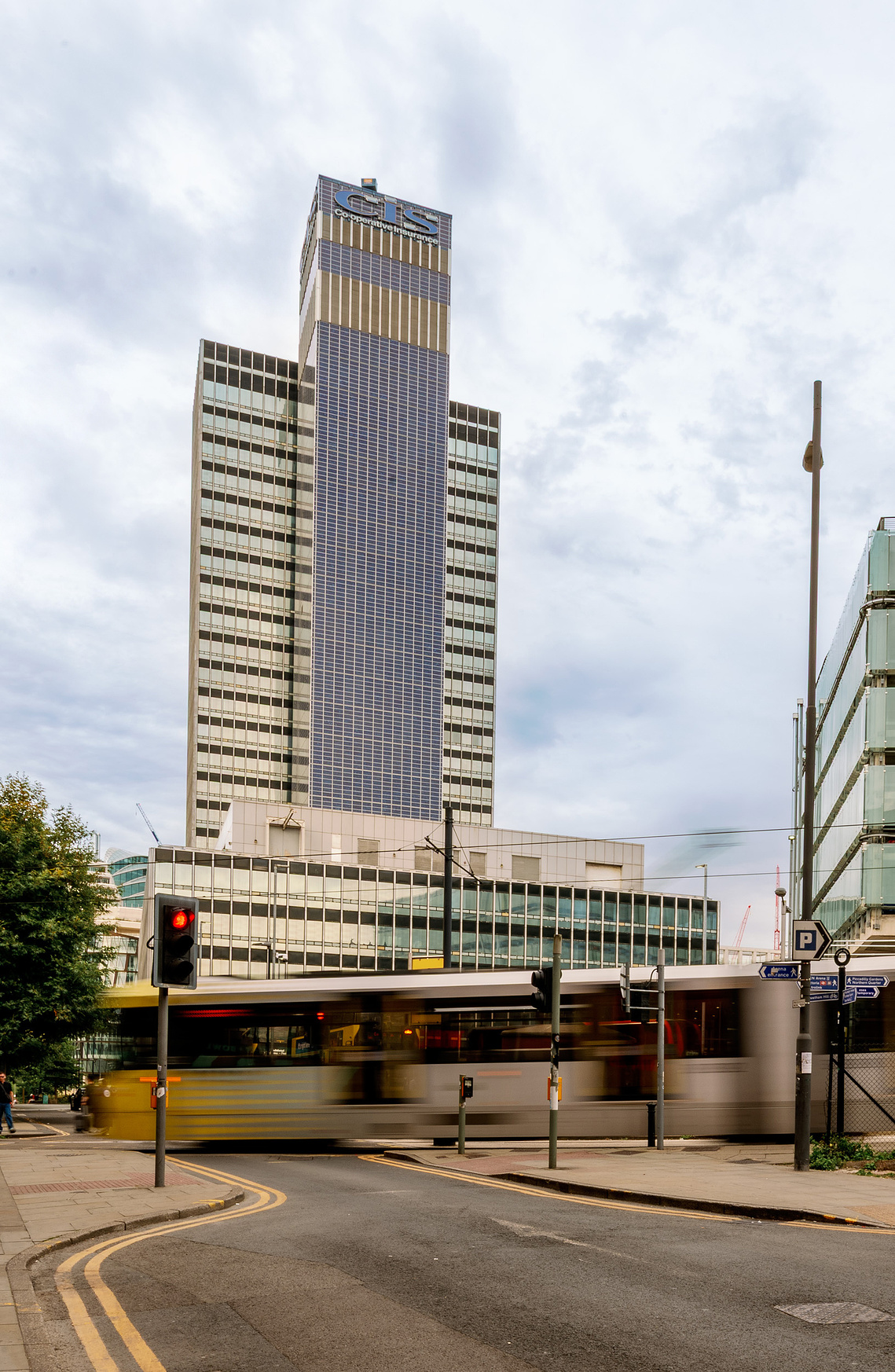 Placemaking architecture photography showing the CIS Building in context with the local surroundings. Manchester tram in foreground