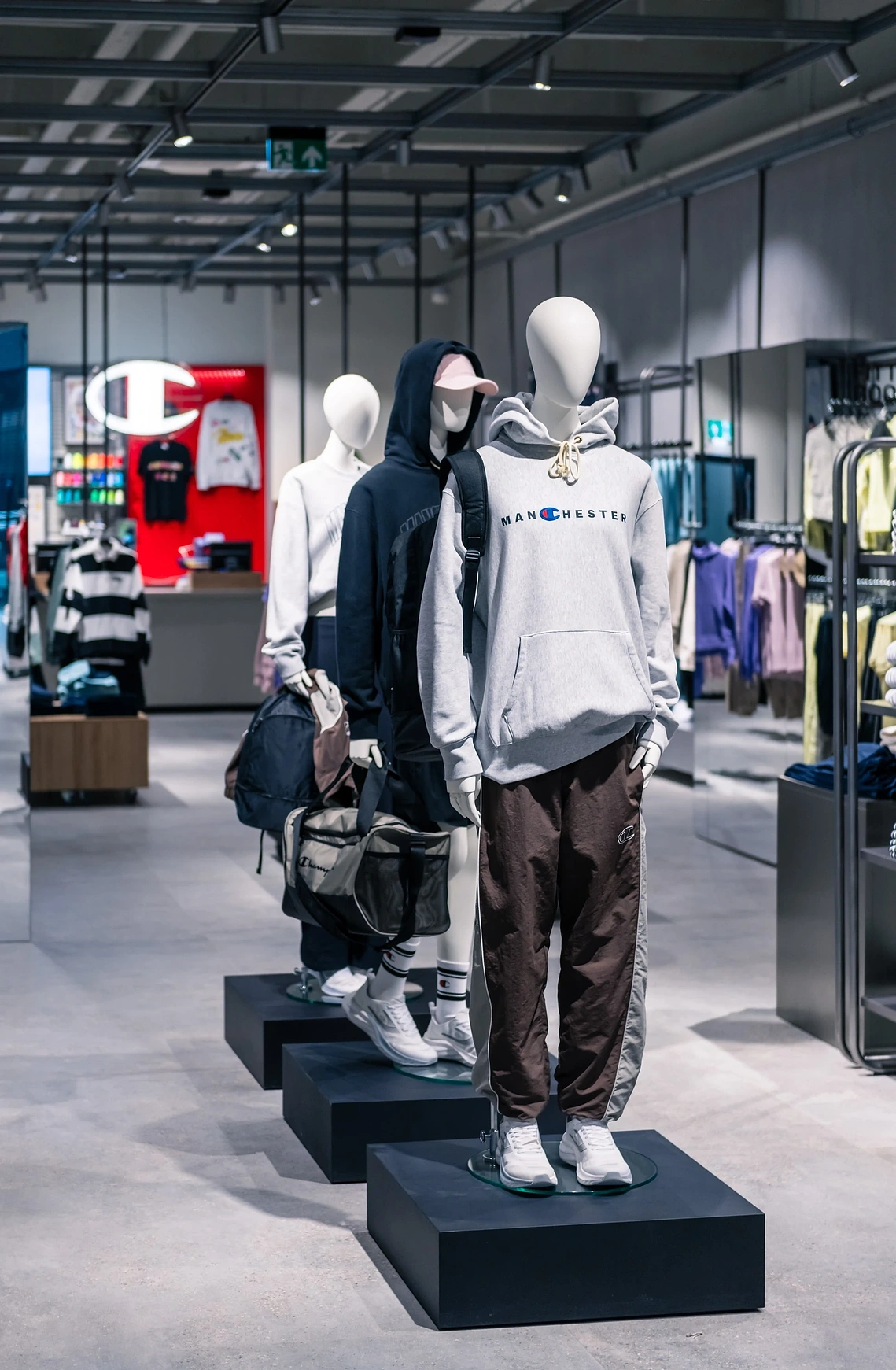 Commercial interior photography showing the main floor layout and product displays in the Champion Manchester store.