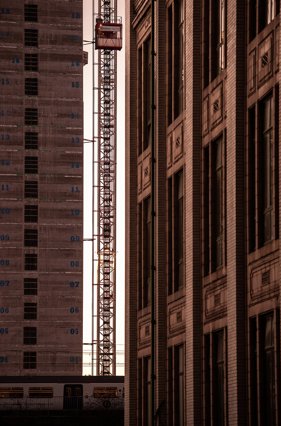 cropped image of modern city buildings with workers and crane