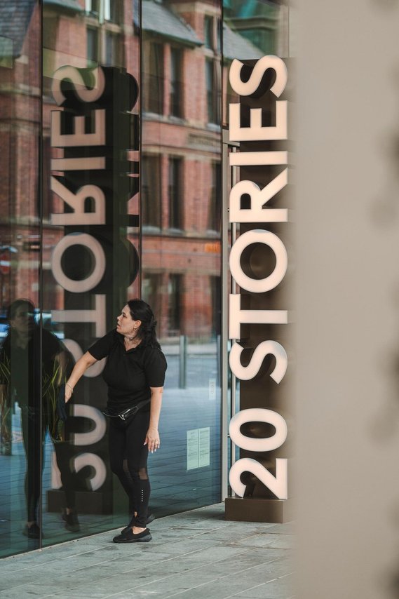 URBAN LIFESTYLE AND LOCAL AREA PHOTOGRAPHY OF SPINNINGFIELDS, MANCHESTER, lifestyle shot of restaurant signage and person cleaning the windows