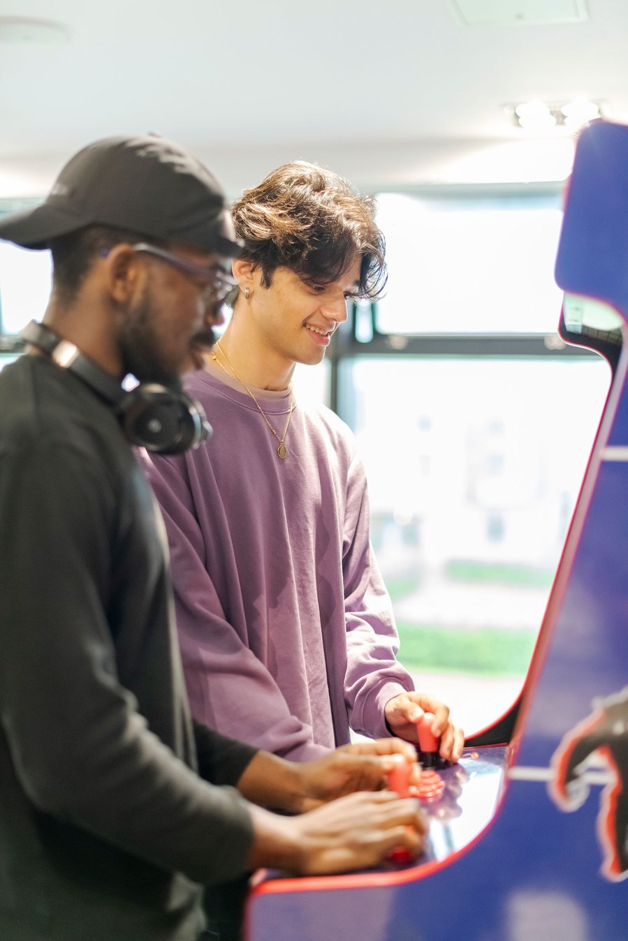 student lifestyle photography, two students playing an arcade game