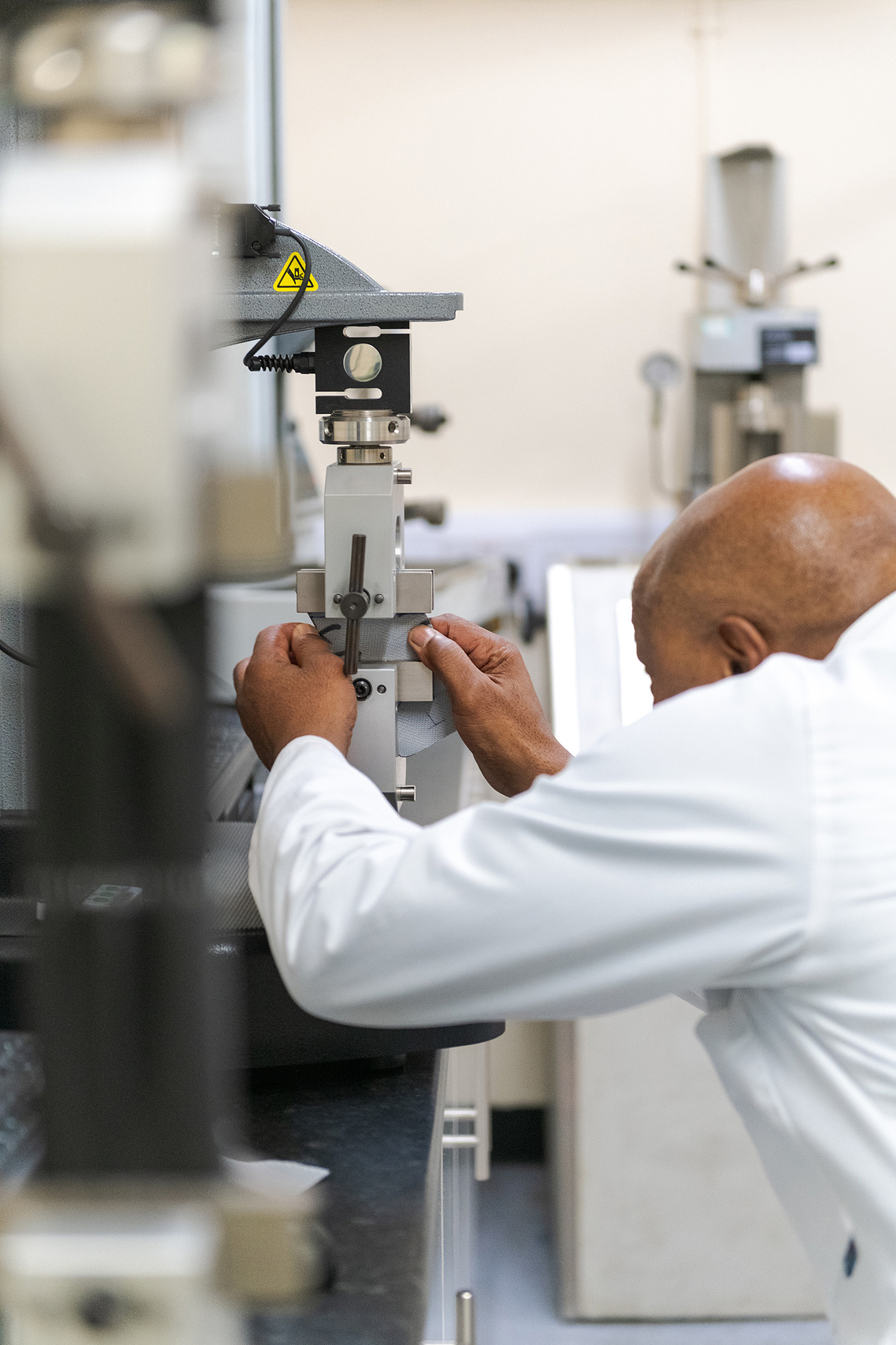 Creative photography for manufacturing brands showcasing lab technician testing product