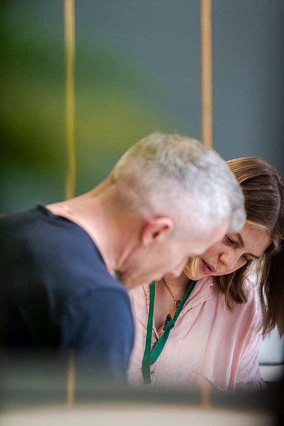 commercial lifestyle photography showing staff in a workplace, interaction between two staff discussing work