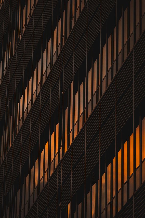 URBAN LIFESTYLE AND LOCAL AREA PHOTOGRAPHY OF SPINNINGFIELDS, MANCHESTER, abstract architecture photography shows cropped view of glass building at night, reflecting sunset colours