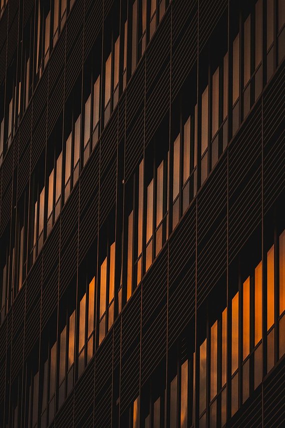 URBAN LIFESTYLE AND LOCAL AREA PHOTOGRAPHY OF SPINNINGFIELDS, MANCHESTER, abstract architecture photography shows cropped view of glass building at night, reflecting sunset colours