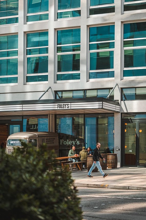 URBAN LIFESTYLE AND LOCAL AREA PHOTOGRAPHY OF SPINNINGFIELDS, MANCHESTER, lifestyle photography shows customers sitting outside coffee shop with person walking past