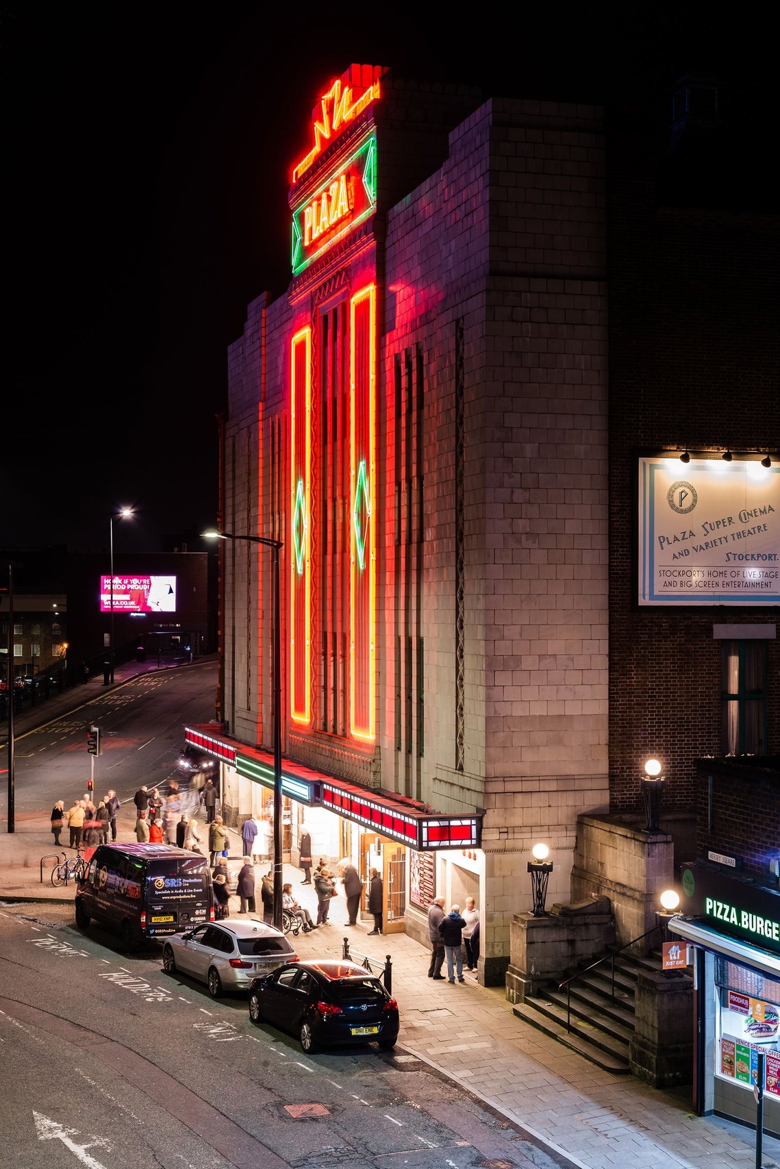 stockport lifestyle photography, local theatre at night with neon lights and customers outside