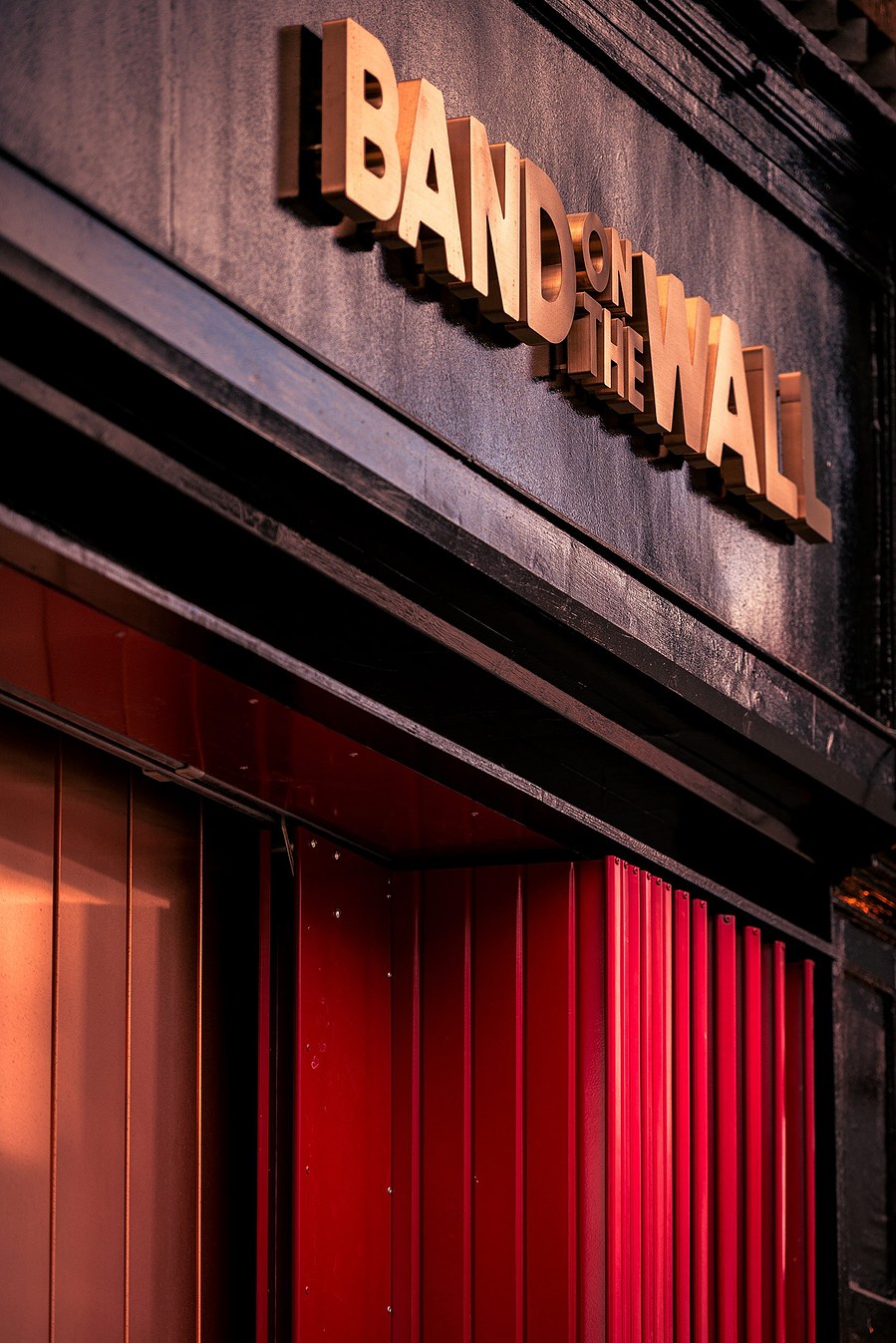 placemaking photography. manchester. norther quarter. architecture. venue. signage of band on the wall