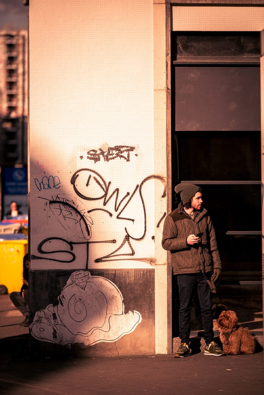 placemaking photography. manchester. norther quarter. architecture. man stood with dog on lead