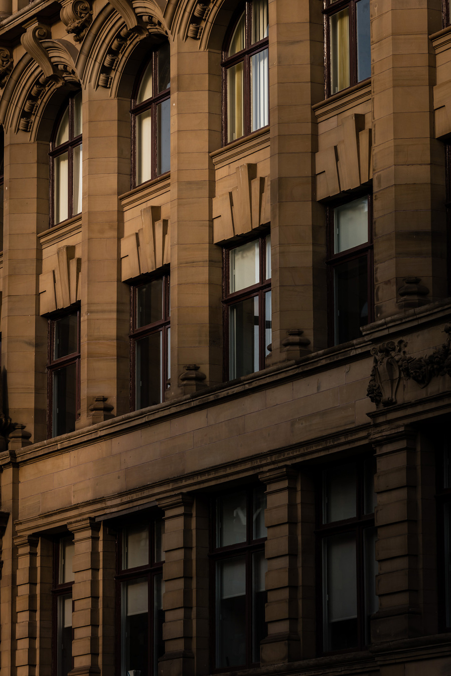 classic manchester architecture. city centre building. photographed with shadows across frontage of brickwork