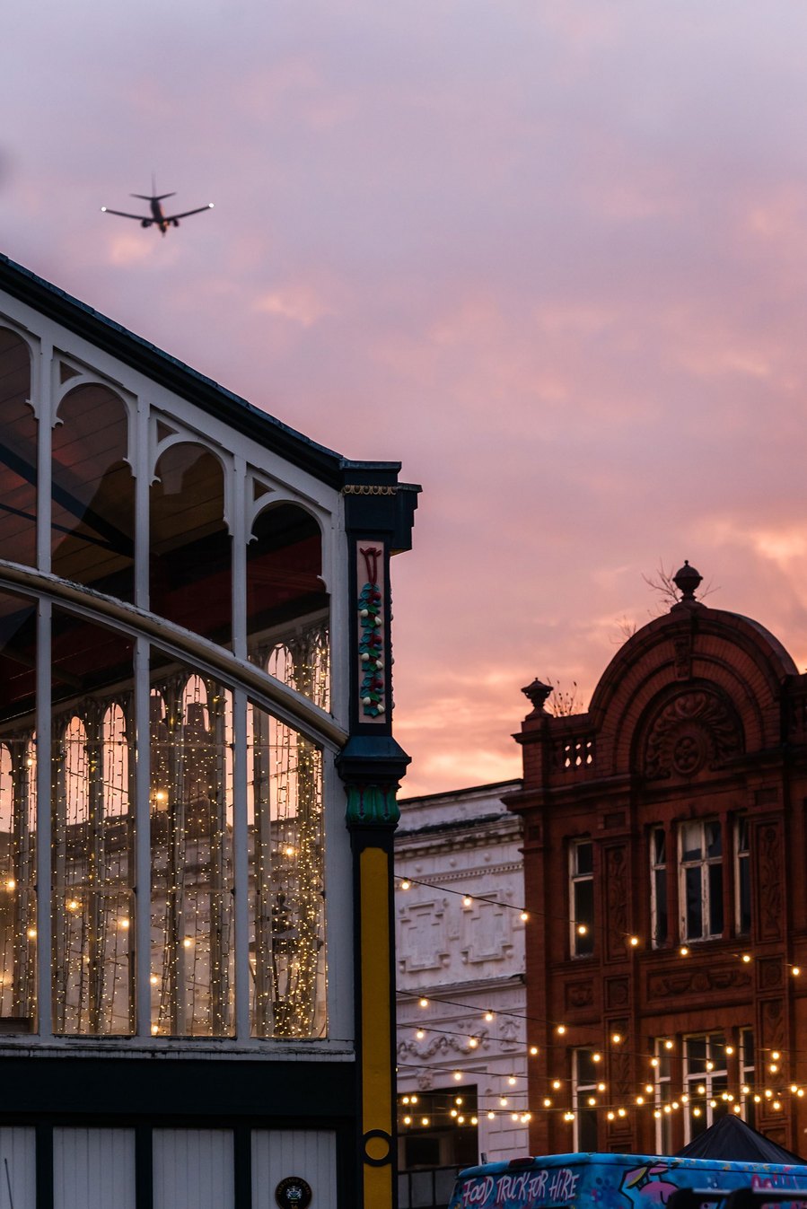 stockport lifestyle and placemaking photography, local street architecture, evening light, airplane in sky