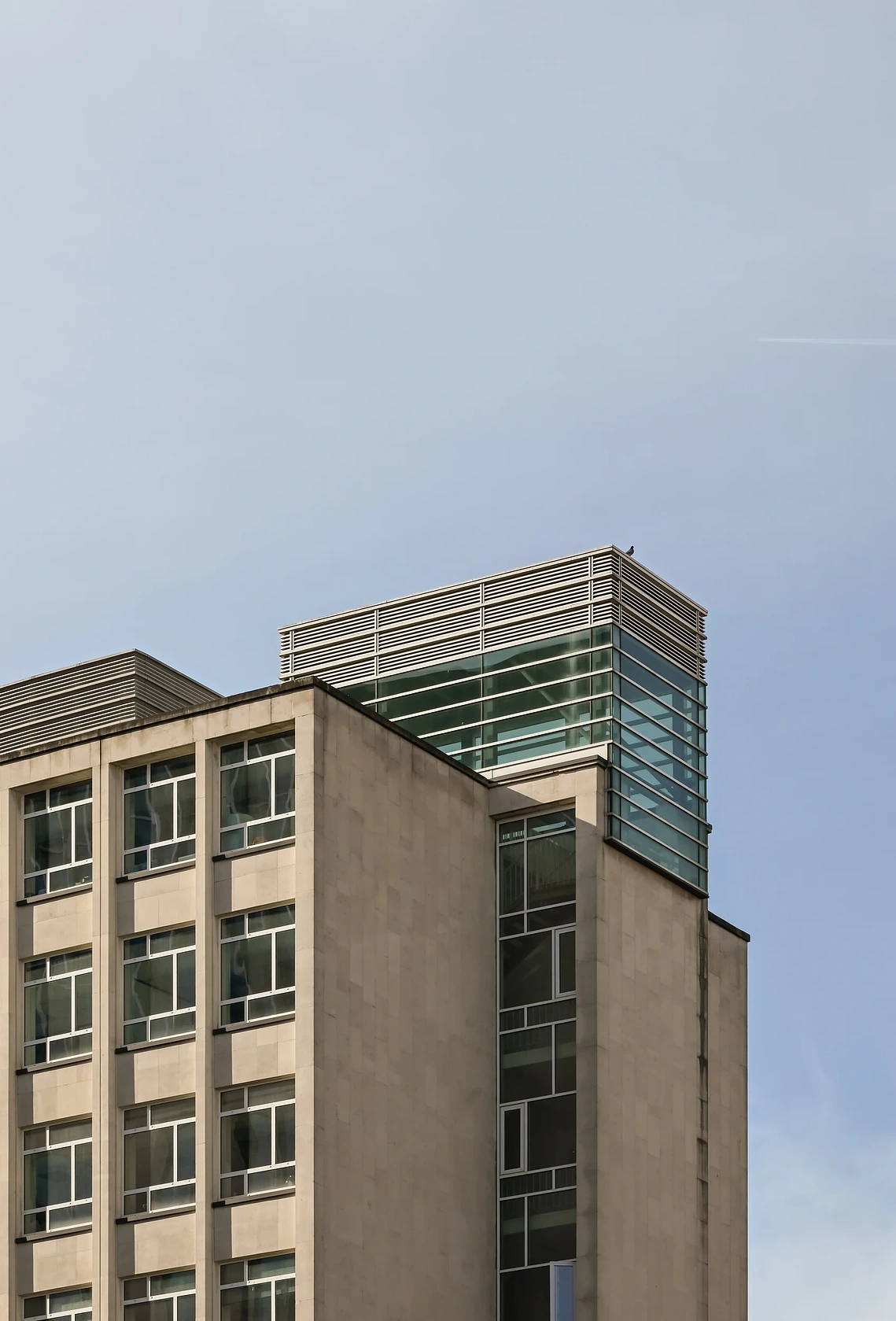 Architectural view looking up a multi-story concrete building
