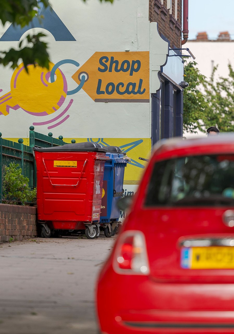 london lifestyle photography, street art saying shop local and red car