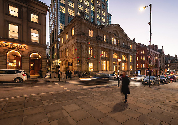 Architecture photography showing a heritage building in Manchester and wider street scene at dusk.