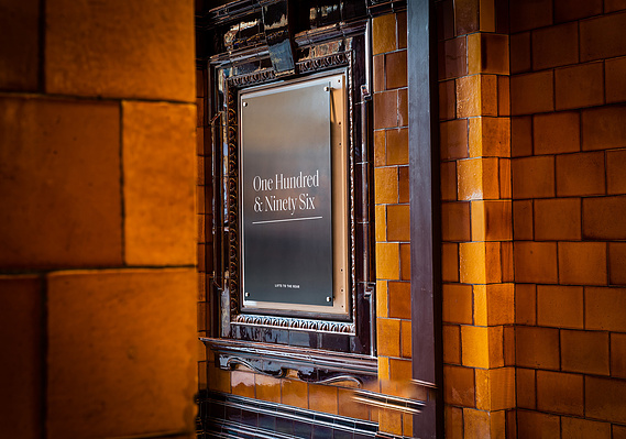 Case Study Photography Cover For Manchester Property Marketing Photographer Captures Aspirational Architecture Photography Of Iconic City Building showing vintage tiled wall with signage