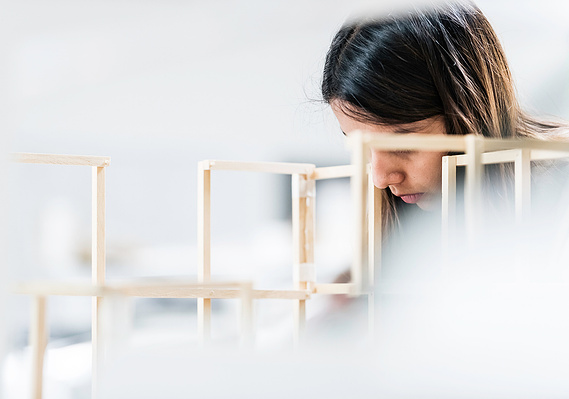 Case Study Photography Cover For Educational Photography For School Of Architecture showing a student concentrating on a building model project 