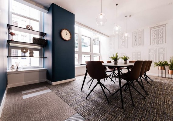 Office interior with long table and multiple chairs. A meeting room. Modern design. Natural light 
