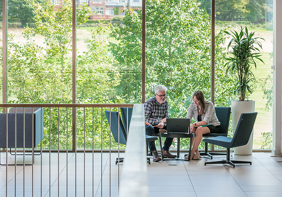 Case Study Photography Cover For Corporate Lifestyle And Commercial Interior Photography For Advertising Campaign showing two professionals having a meeting in open plan area