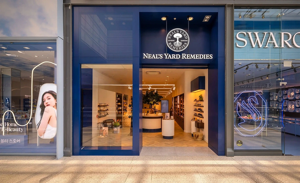 Storefront retail photography of the glazed Neal's Yard Remedies facade in Manchester Arndale.
