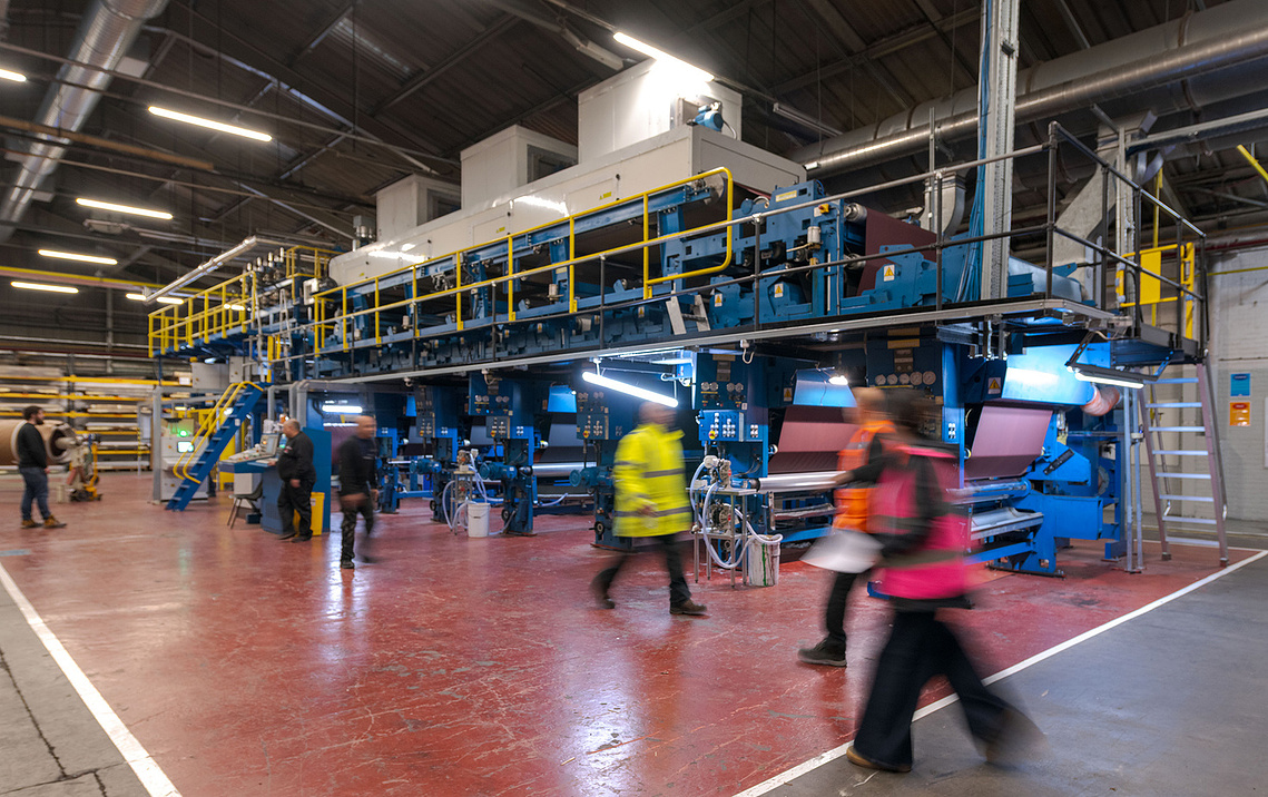 Documentary manufacturing photography capturing  workers and machinery during the Ambla fabric production process.