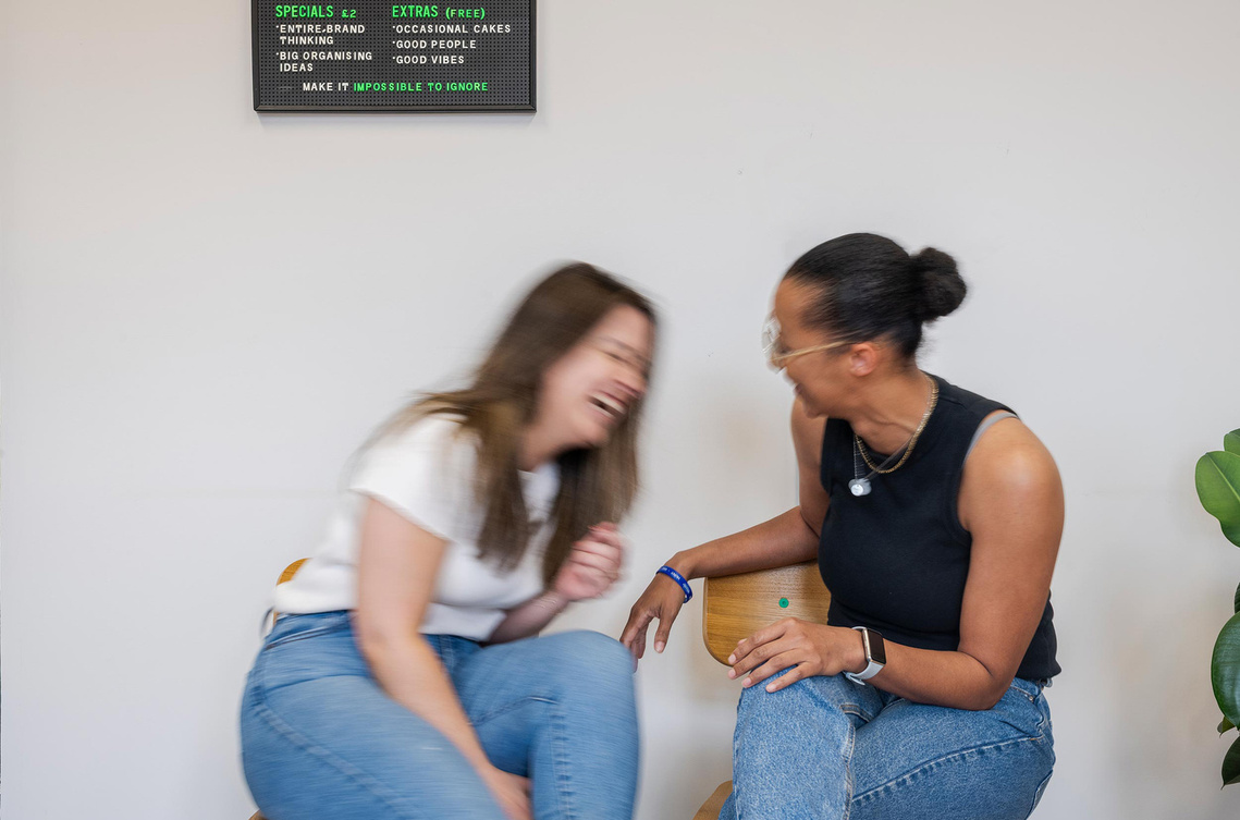 commercial lifestyle photography, two people laughing and chatting 