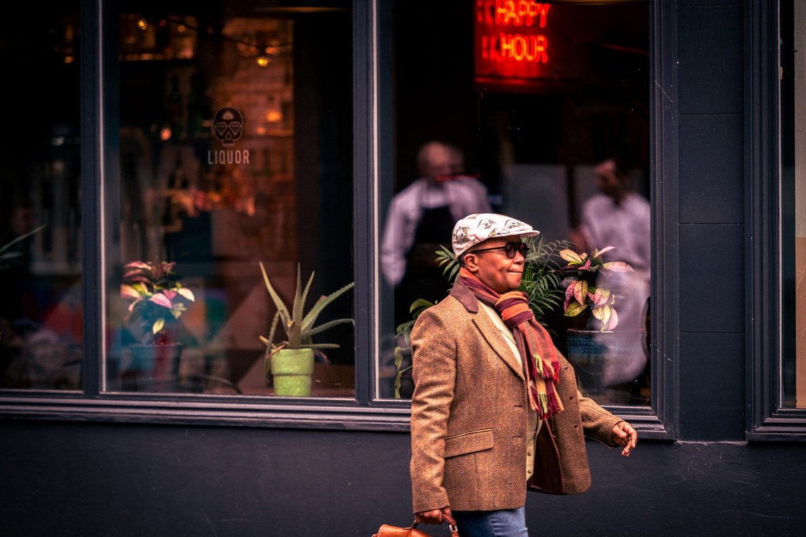 urban lifestyle photography. smartly dressed man strides past a shop window
