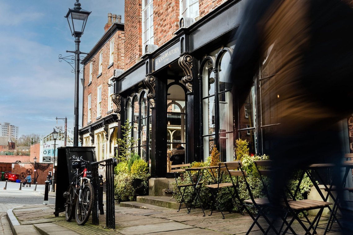 stockport placemaking photography, daytime, blue sky, local cafe exterior
