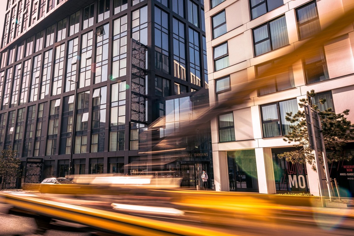 city photography. architectural photo of hotel with blurred car in foreground 