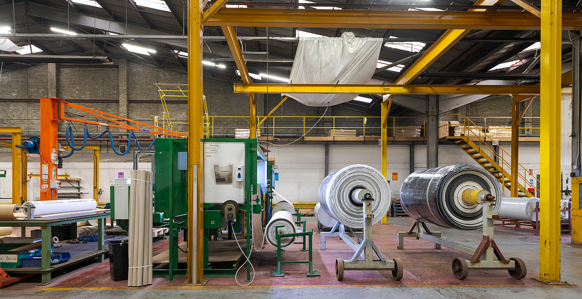 Creative photography for manufacturing brands. Factory shot showing side view of a process