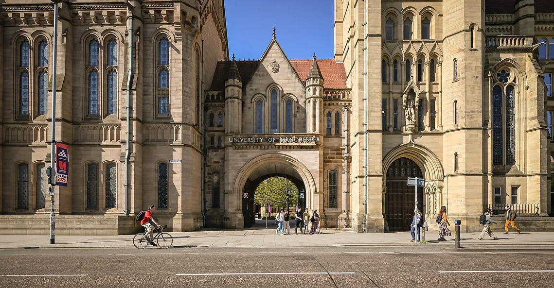 Students walking in lifestyle shot showing University heritage architecture 