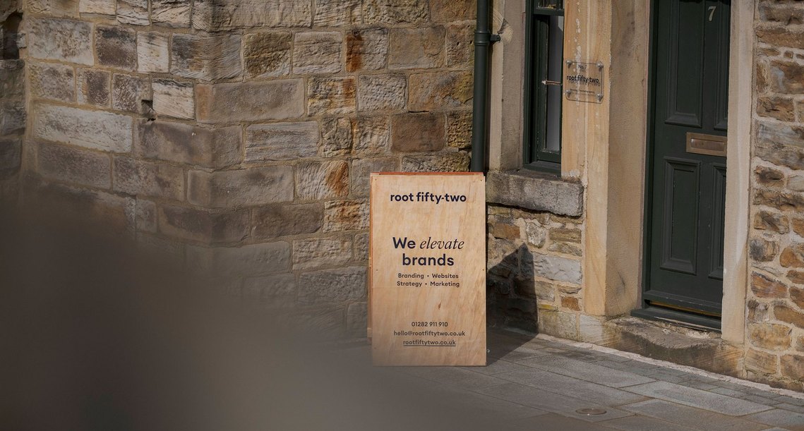 commercial lifestyle and office lifestyle, workplace, exterior shot of studio with a-board showing company branding