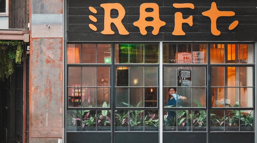 URBAN LIFESTYLE AND LOCAL AREA PHOTOGRAPHY OF SPINNINGFIELDS, MANCHESTER, shot of a bar window with worker inside cleaning