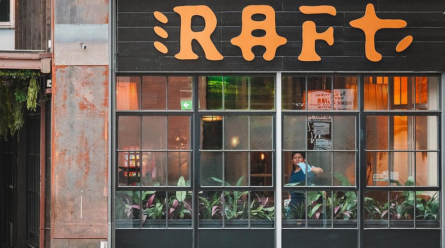 URBAN LIFESTYLE AND LOCAL AREA PHOTOGRAPHY OF SPINNINGFIELDS, MANCHESTER, shot of a bar window with worker inside cleaning