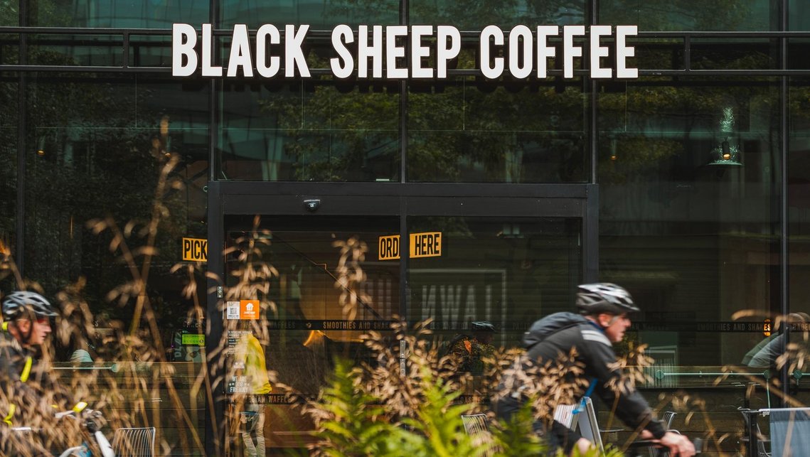 URBAN LIFESTYLE AND LOCAL AREA PHOTOGRAPHY OF SPINNINGFIELDS, MANCHESTER, lifestyle photography showing a coffee shop and a cyclist going past