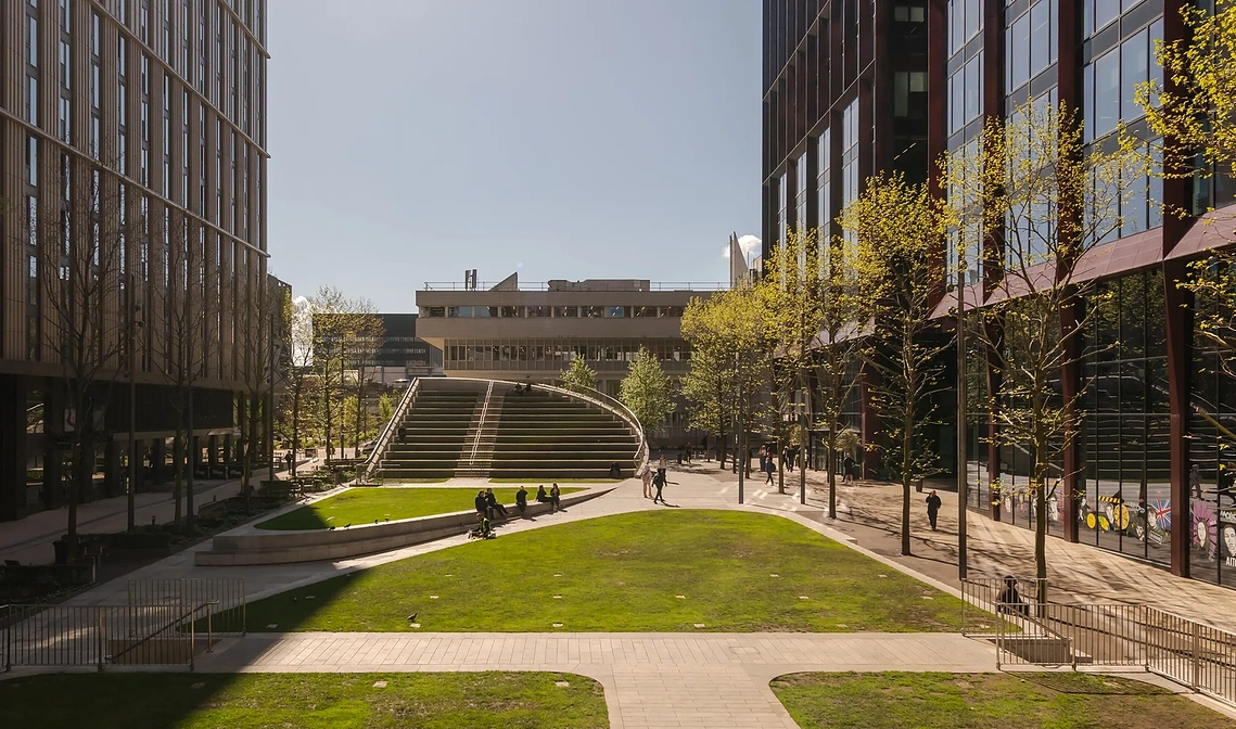 Exterior architectural photograph showing steps in circle square manchester and people sitting