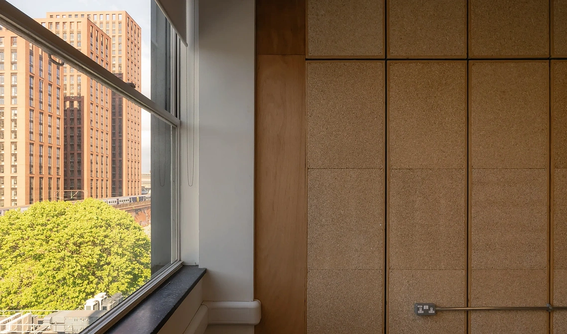 Sustainable office fitout photography showing demountable partition walls and acoustic panels inside a Manchester climate-tech hub. 