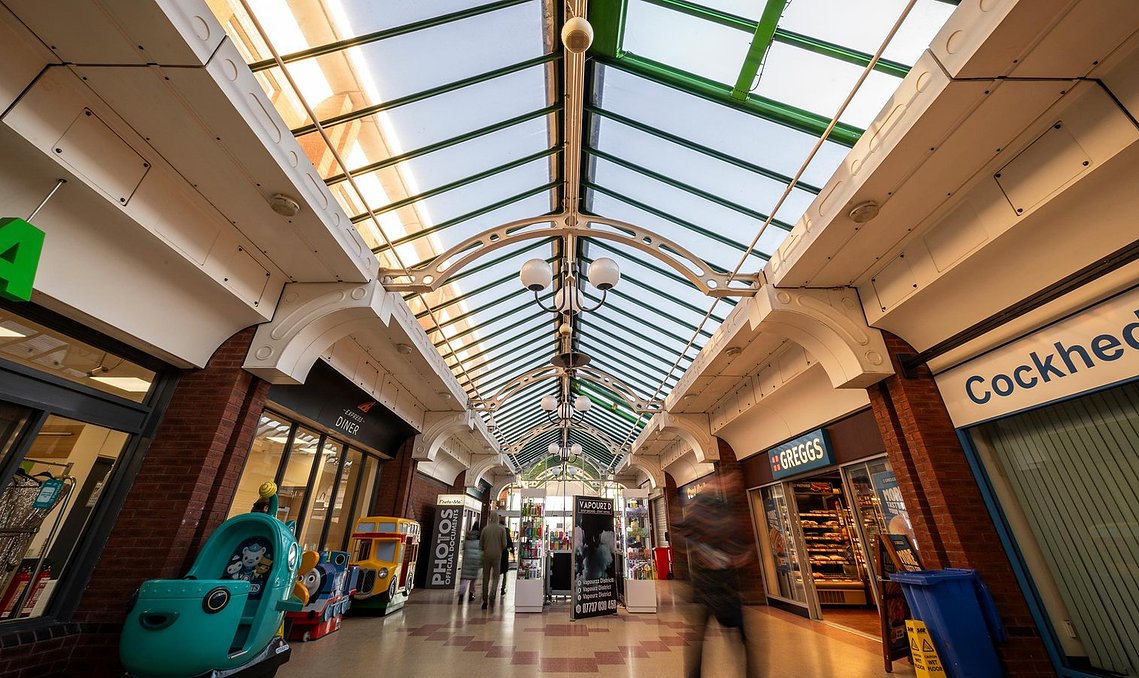 interior of shopping centre foyer with glass roof
