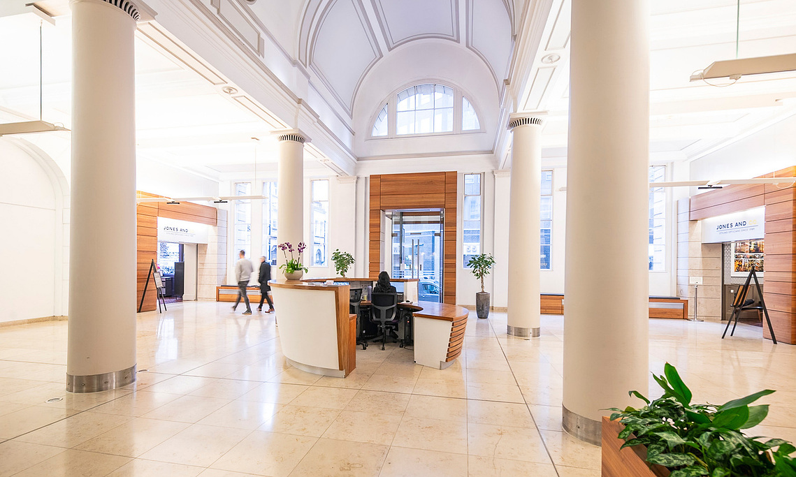 vast and impressive lobby area in period building, interior and architecture photography with people moving 