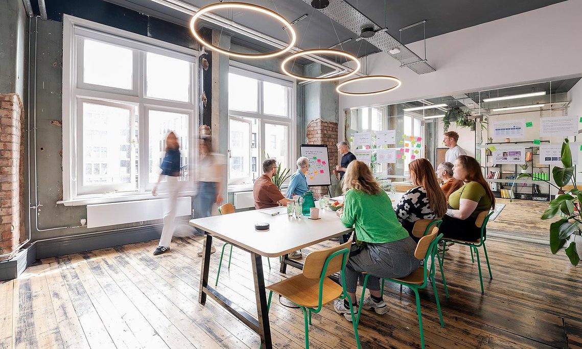 commercial lifestyle photography showing staff in the workplace, warehouse style office, meeting room, people sat and standing and walking