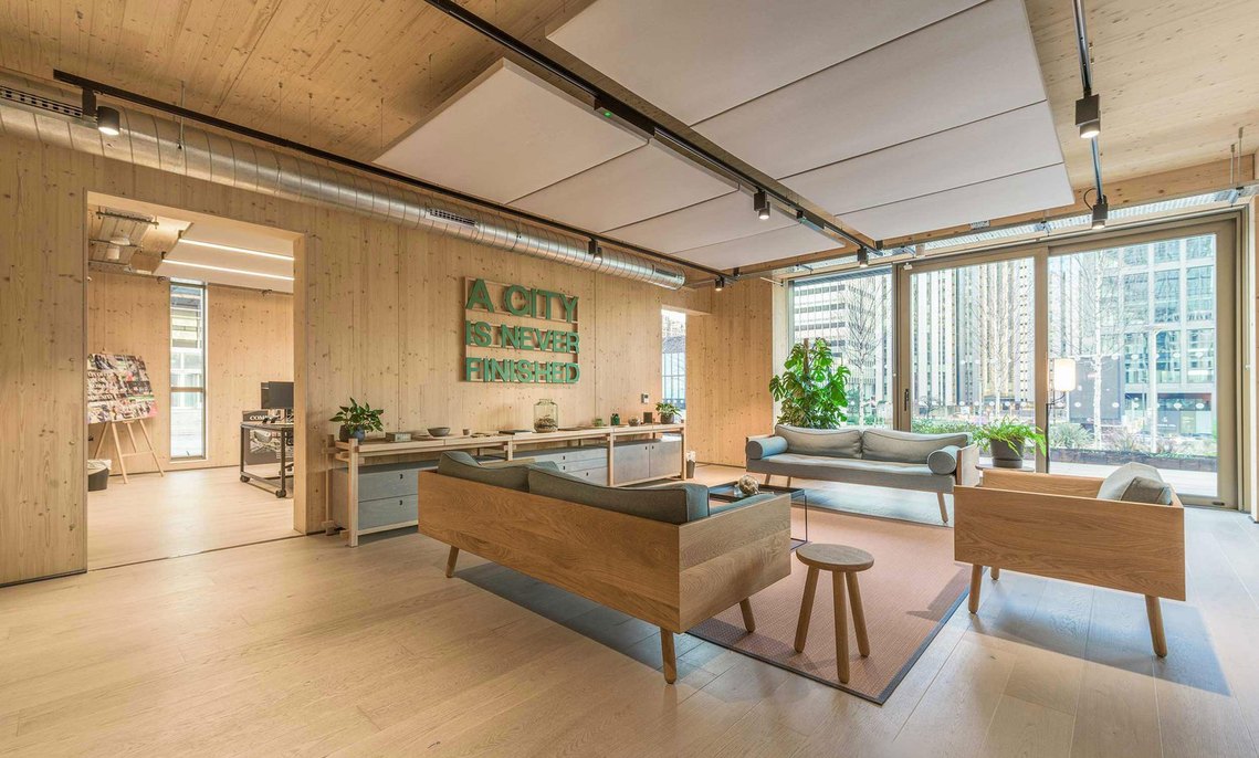 commercial interiors for architecture, Modern office lounge with wooden furnishings and city view.
