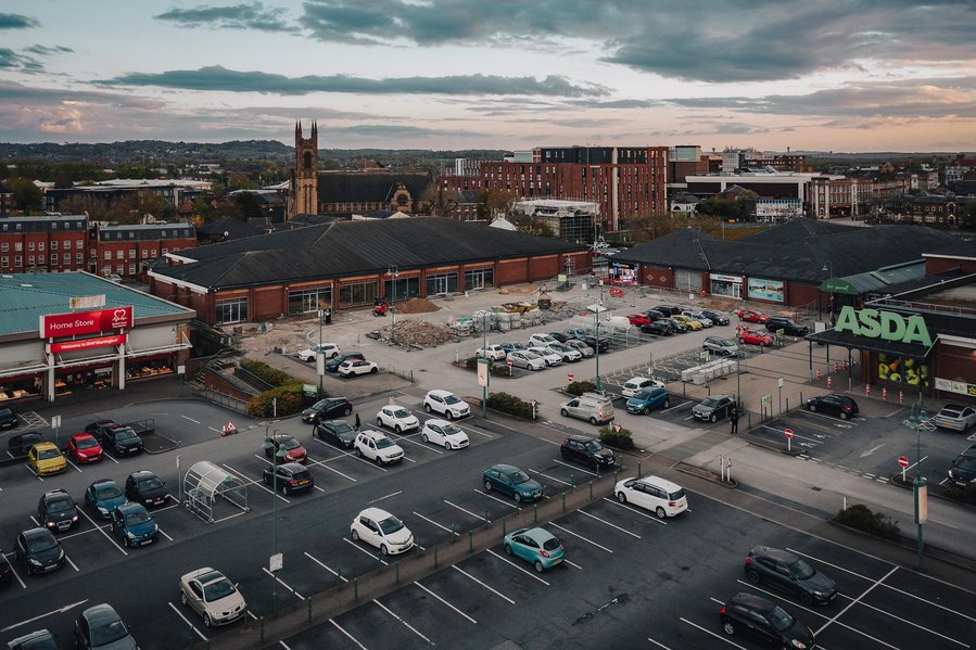construction site, shopping centre, demolition and rubble, drone shot at evening