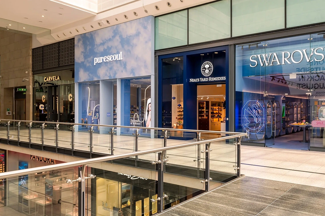 Commercial retail photography of the glazed Neal's Yard Remedies facade in Manchester Arndale.