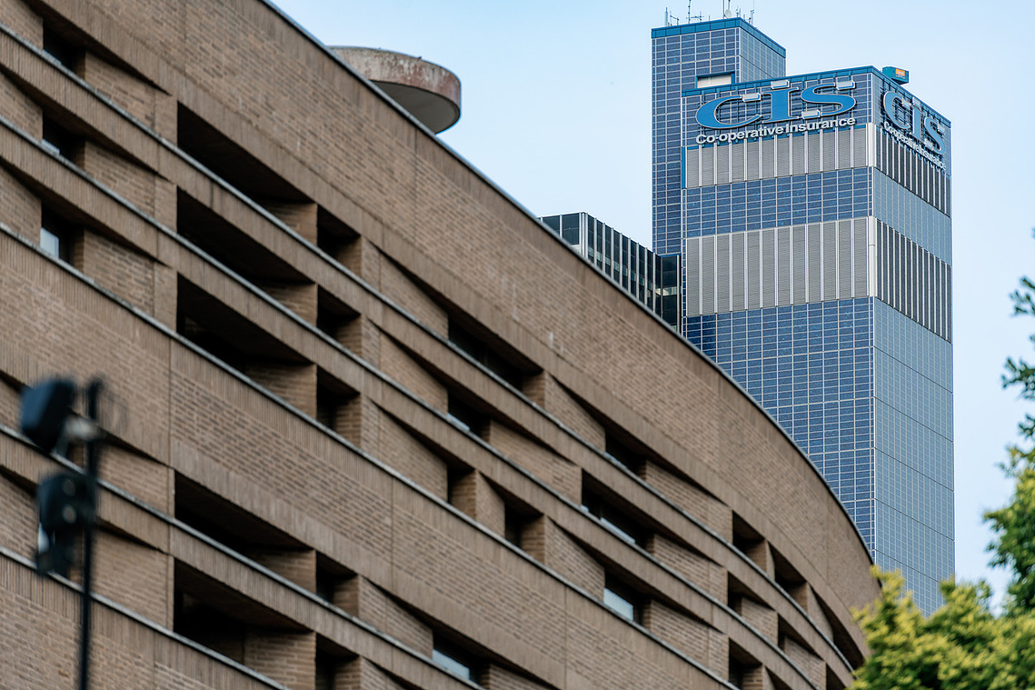 Placemaking architecture photography showing the CIS Building rising above Manchester. Concrete building in foreground.